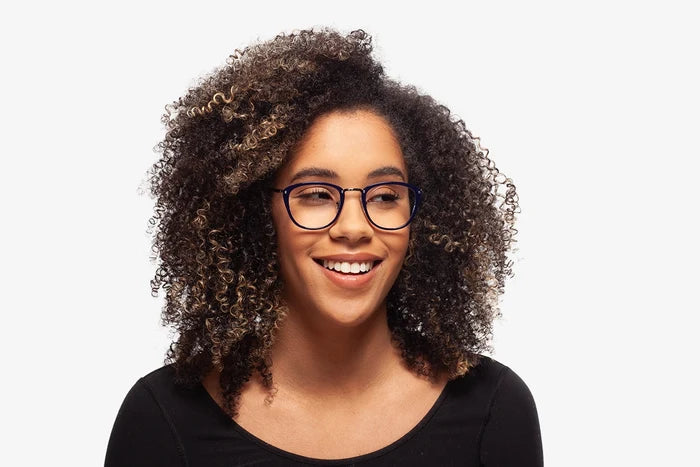 Blue Casey eyeglasses by Chemistrie worn by female model, front view