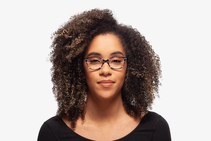 Blue Laura eyeglasses by Chemistrie worn by female model, front view