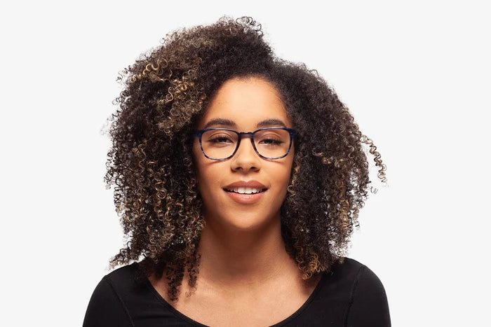 Blue Logan eyeglasses by Chemistrie worn by female model, front view
